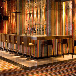 Photo of bar and seats inside Origins Nightclub